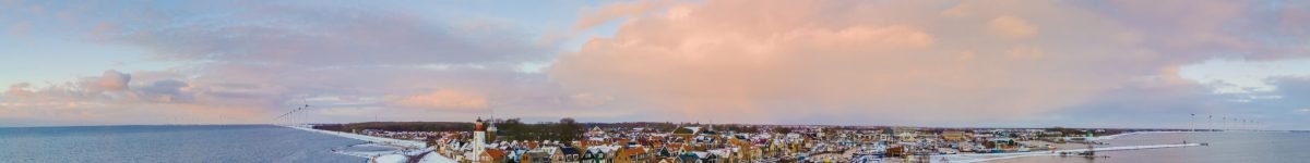 panoramic view of the Lighthouse of Urk during winter with snow landscape in the Netherlands